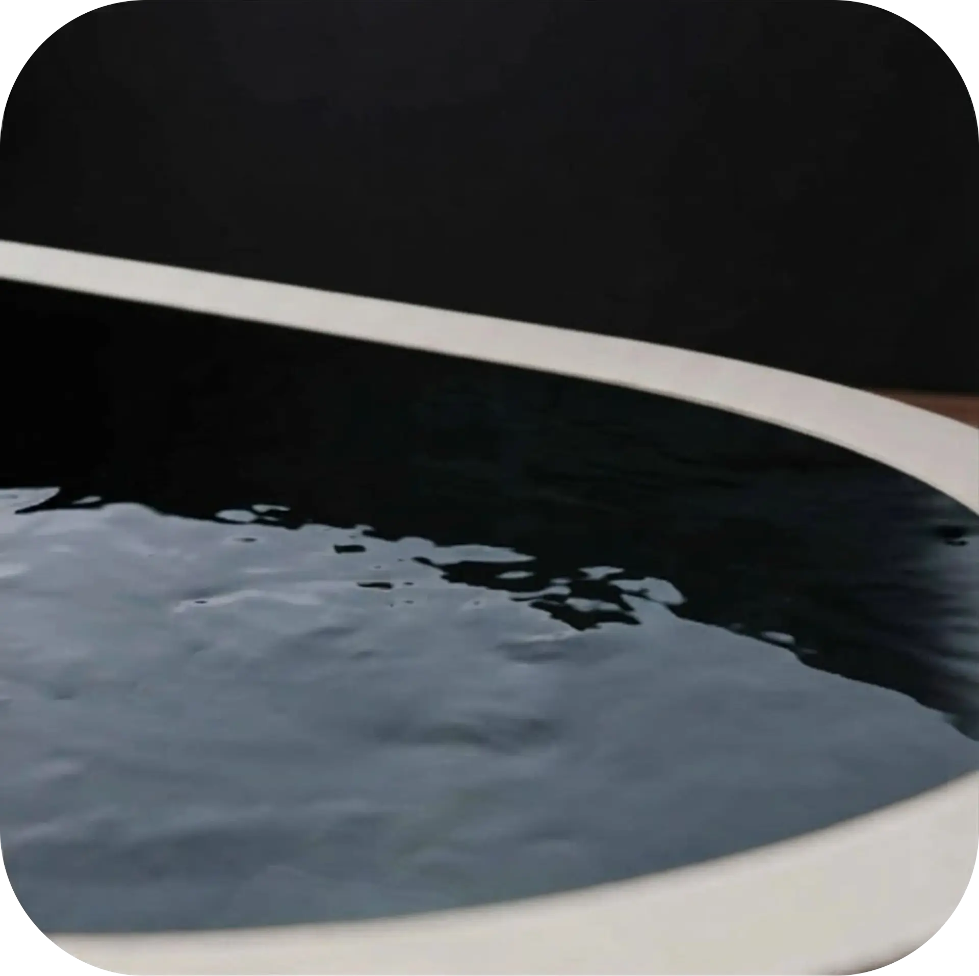 Water surface in a dark cold plunge pool