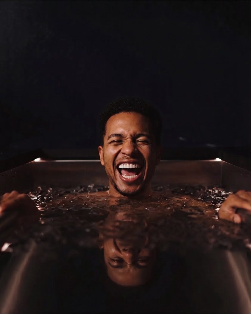 Man laughing in a dark plunge pool