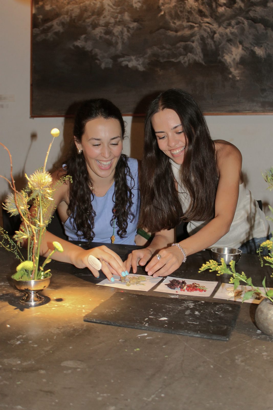 Two women preparing food at a workshop table